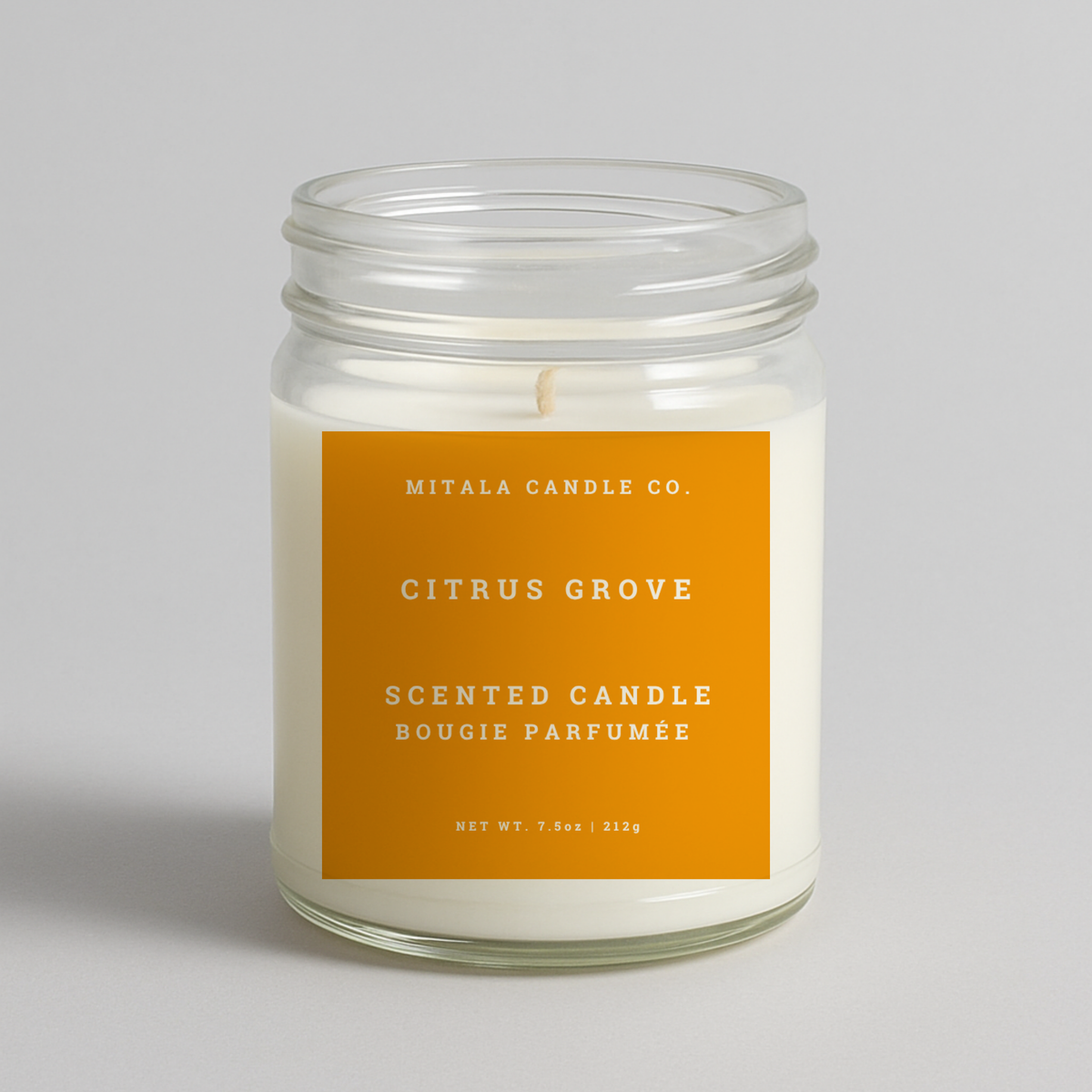 Mitala Candle Co. Citrus Grove scented candle with orange label, 7.5oz, on light gray background