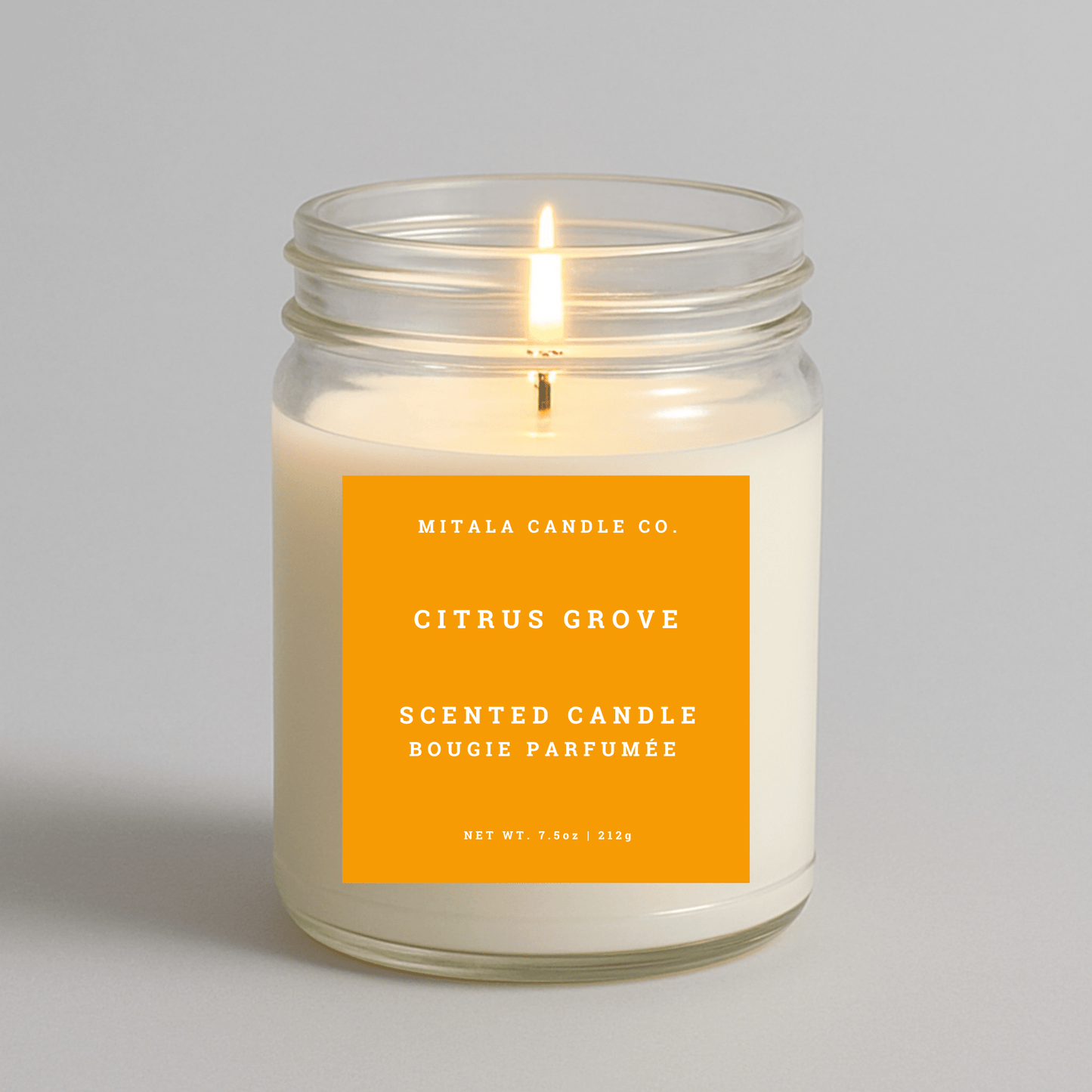 Mitala Candle Co. Citrus Grove scented candle with a yellow label on a gray background
