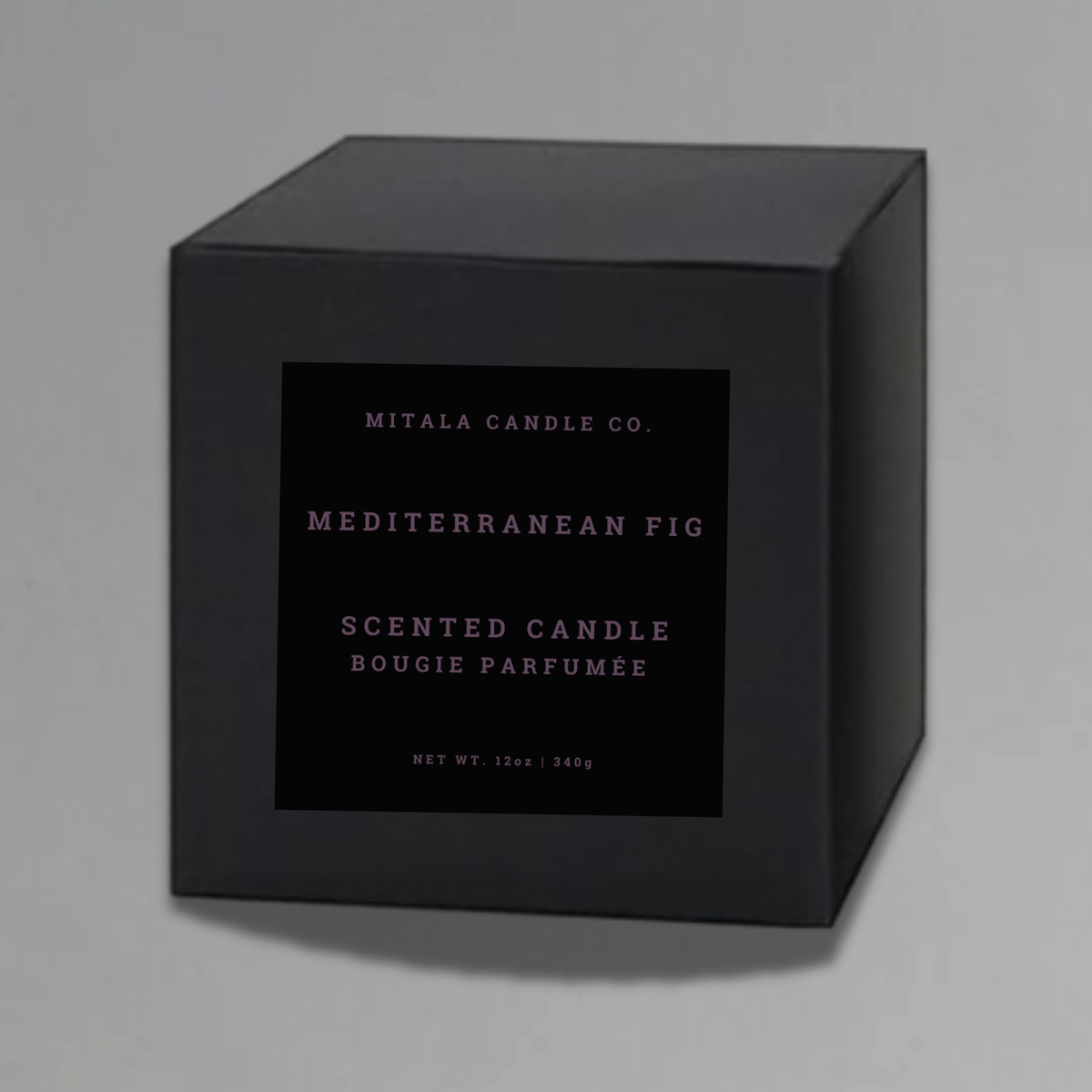 Luxury 12oz soy candle 'Mediterranean Fig' by Mitala Candle Co. next to white gift box on gray background