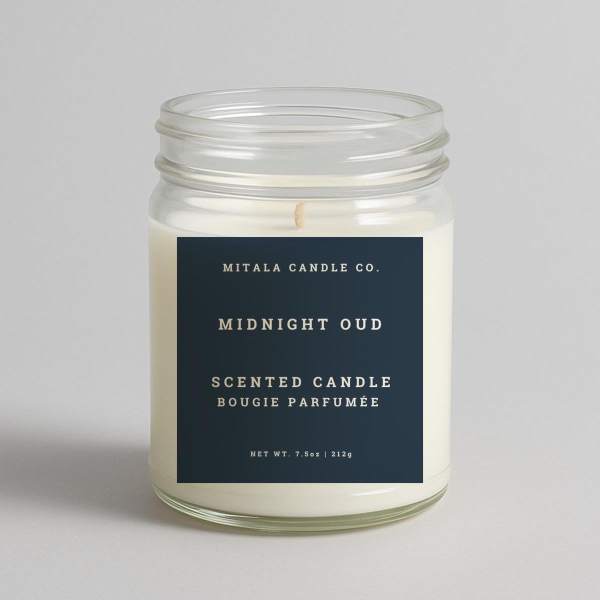 Mitala Candle Co. Midnight Oud scented candle with blue label, 7.5oz, on light gray background