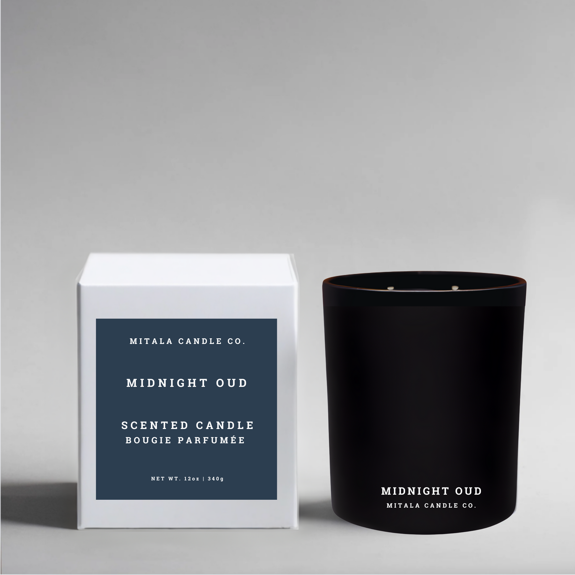soy wax candle labeled 'Midnight Oud' with a white gift box on a gray background