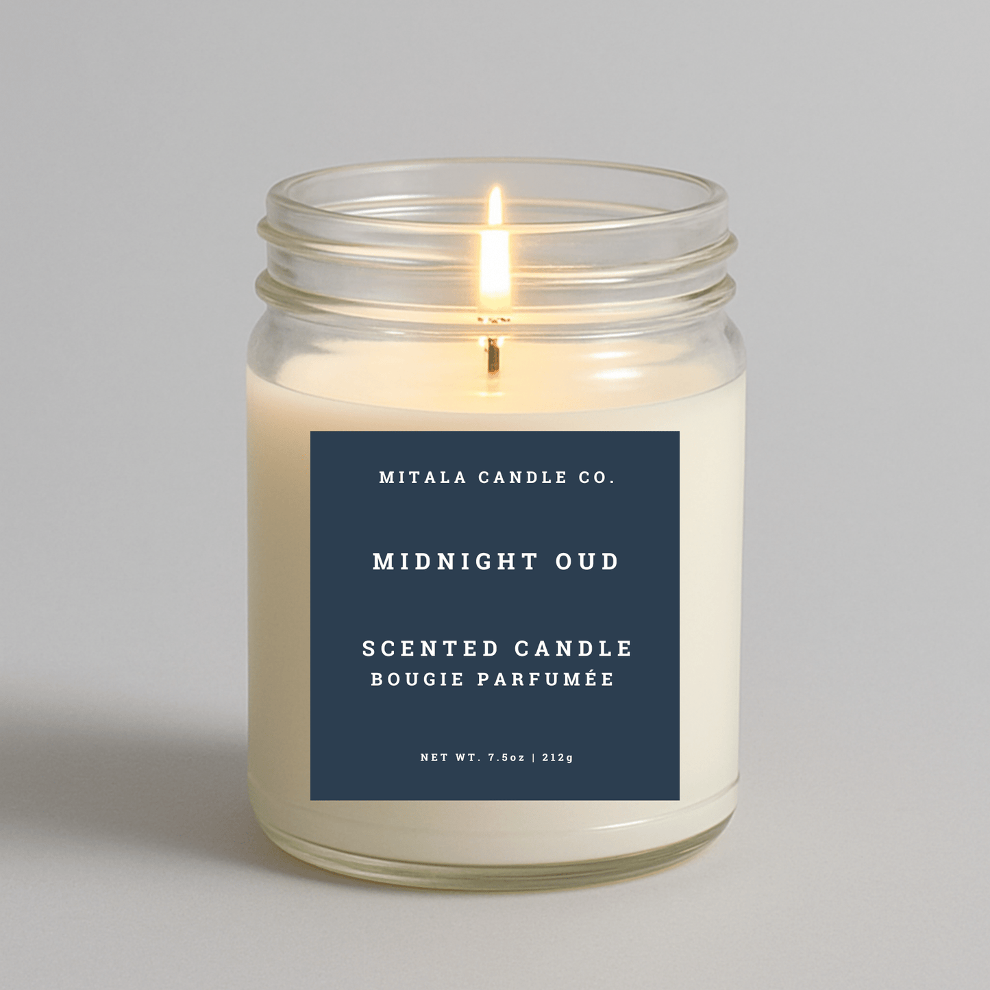 Mitala Candle Co. Midnight Oud scented candle with a blue label on a gray background