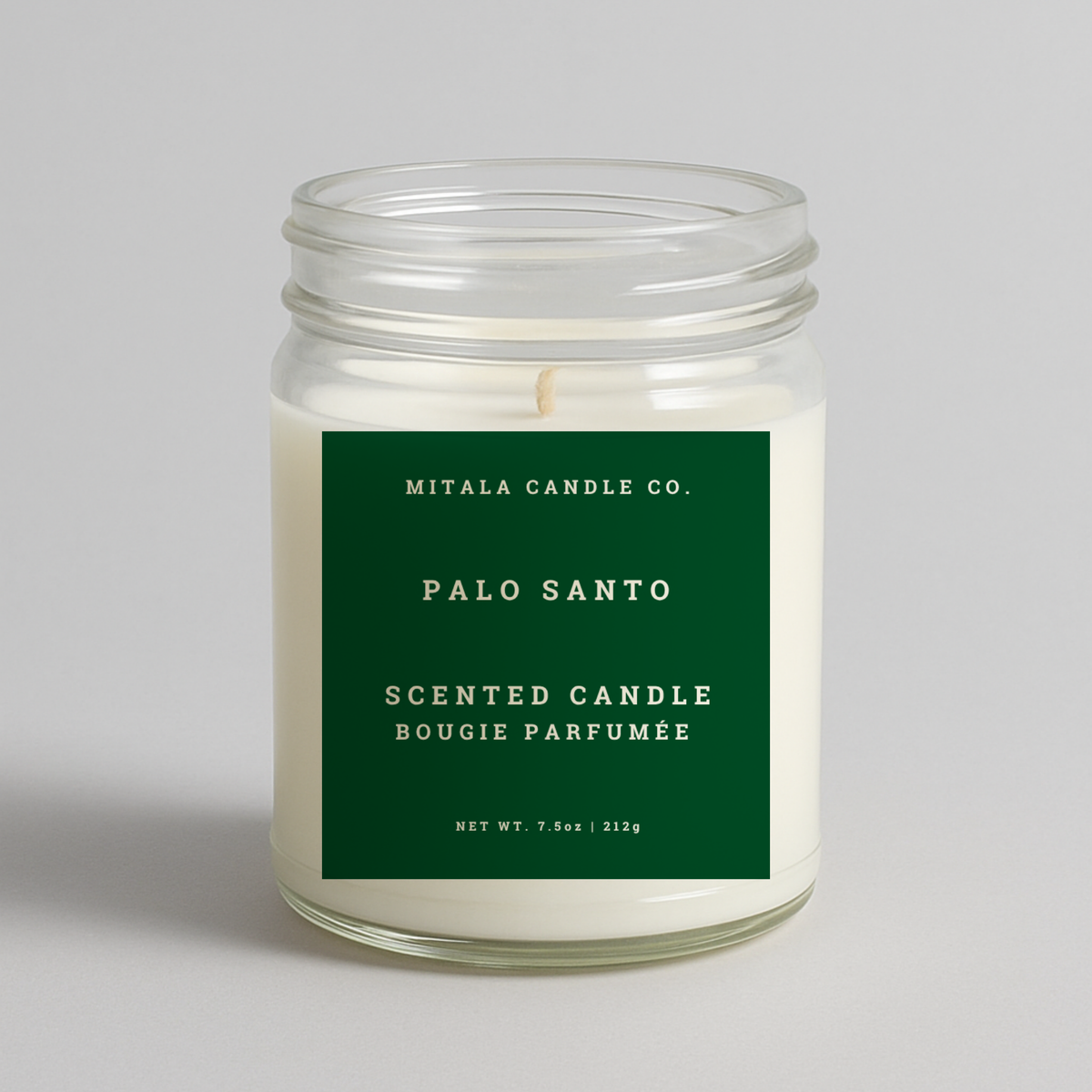 Mitala Candle Co. Palo Santo scented candle with green label, 7.5oz, on light gray background