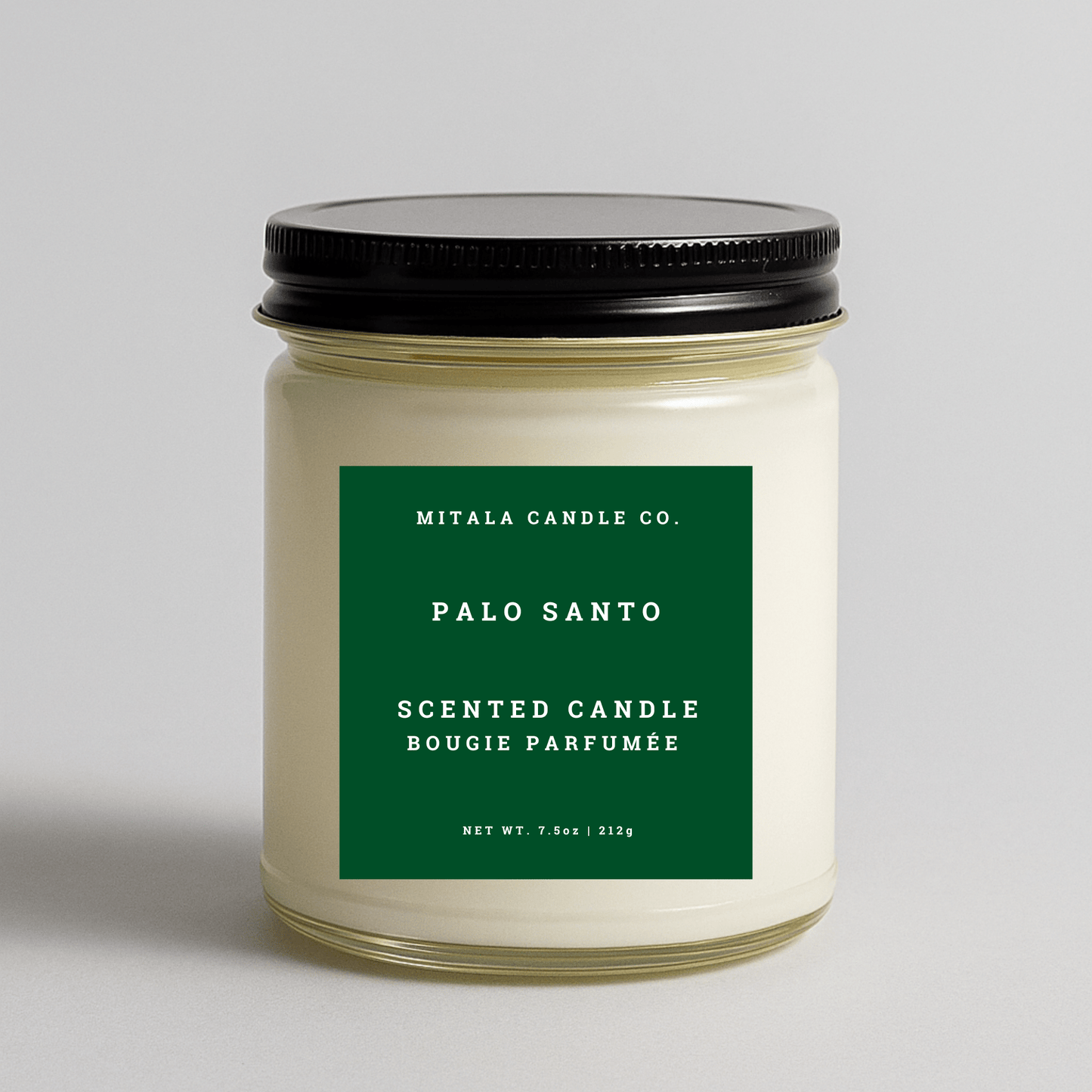 Mitala Candle Co. Palo Santo scented candle with a green label on a light gray background