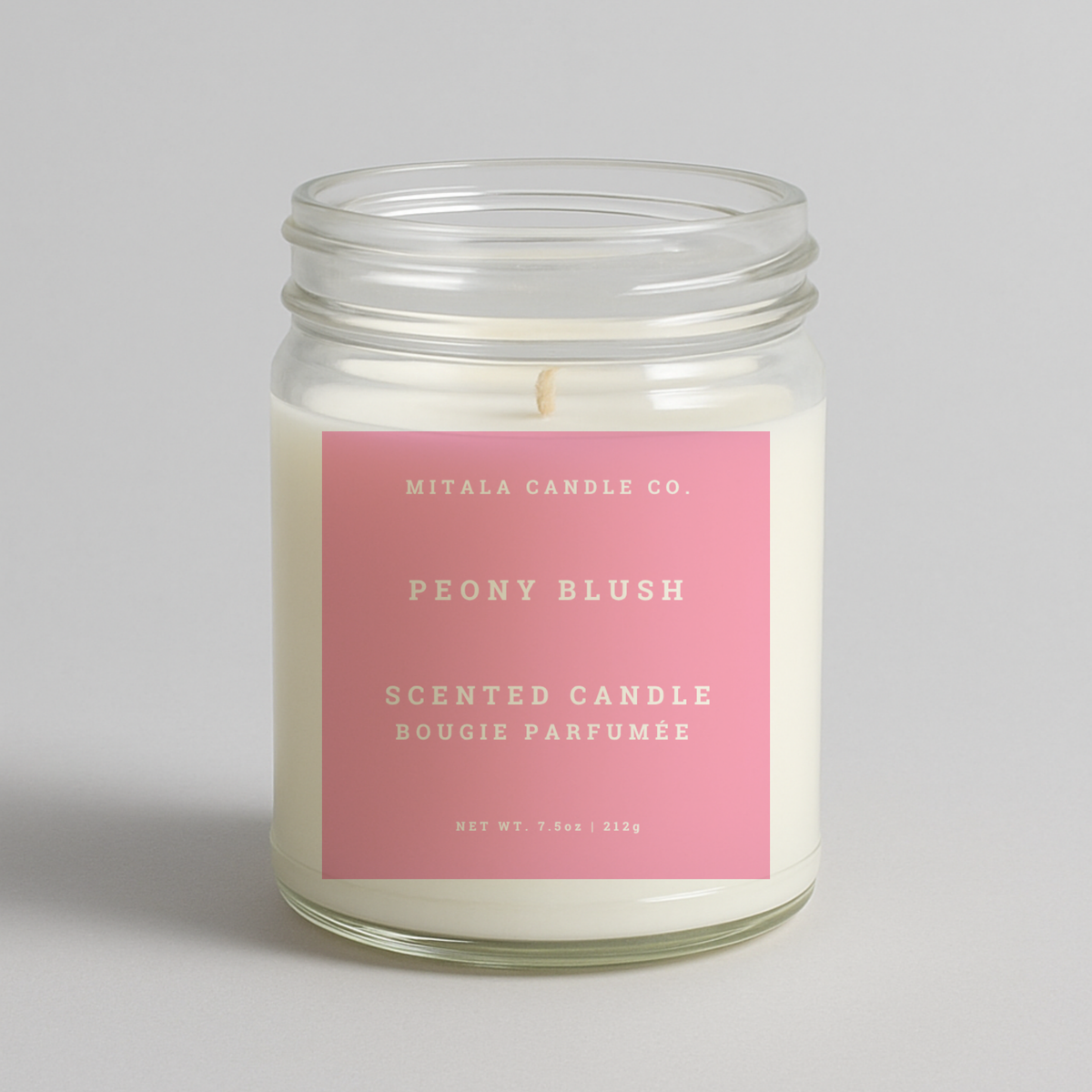 Mitala Candle Co. Peony Blush scented candle with pink label, 7.5oz, on light gray background