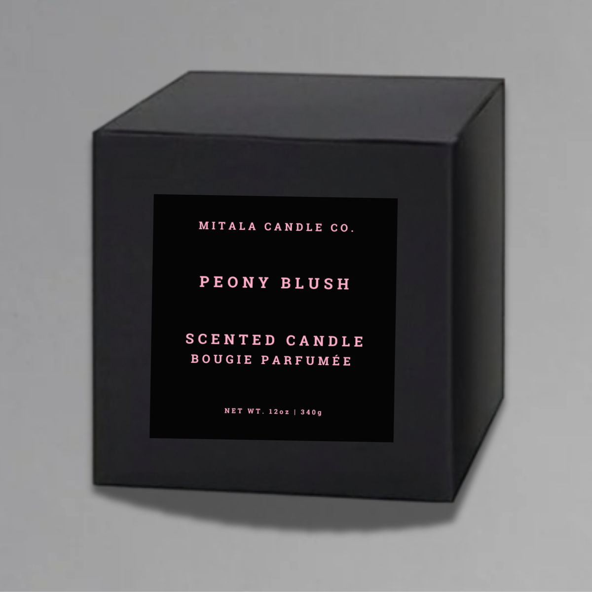 Luxury 12oz soy candle 'Peony Blush' by Mitala Candle Co. next to white gift box on gray background