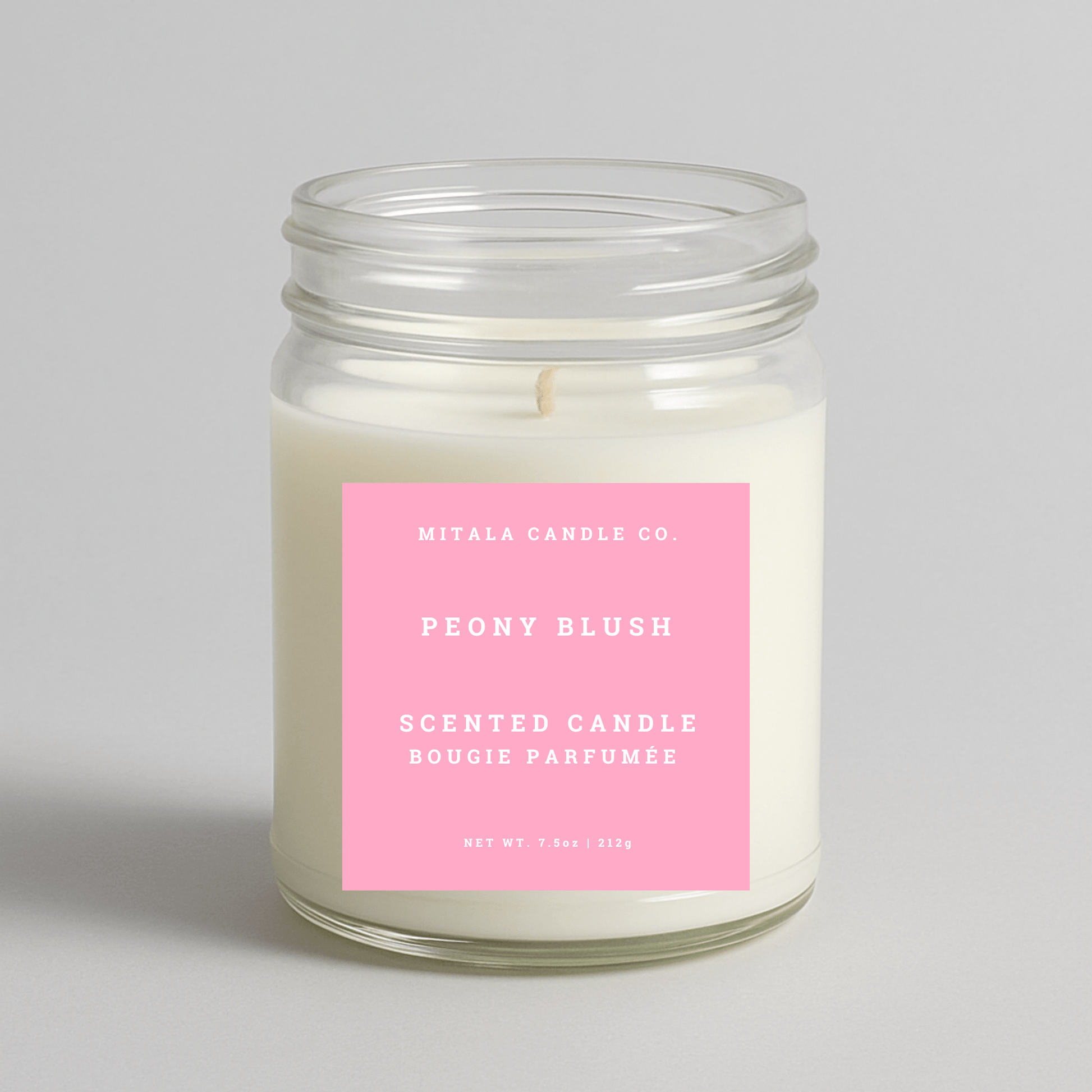 Mitala Candle Co. Peony Blush scented candle with a pink label on a light gray background