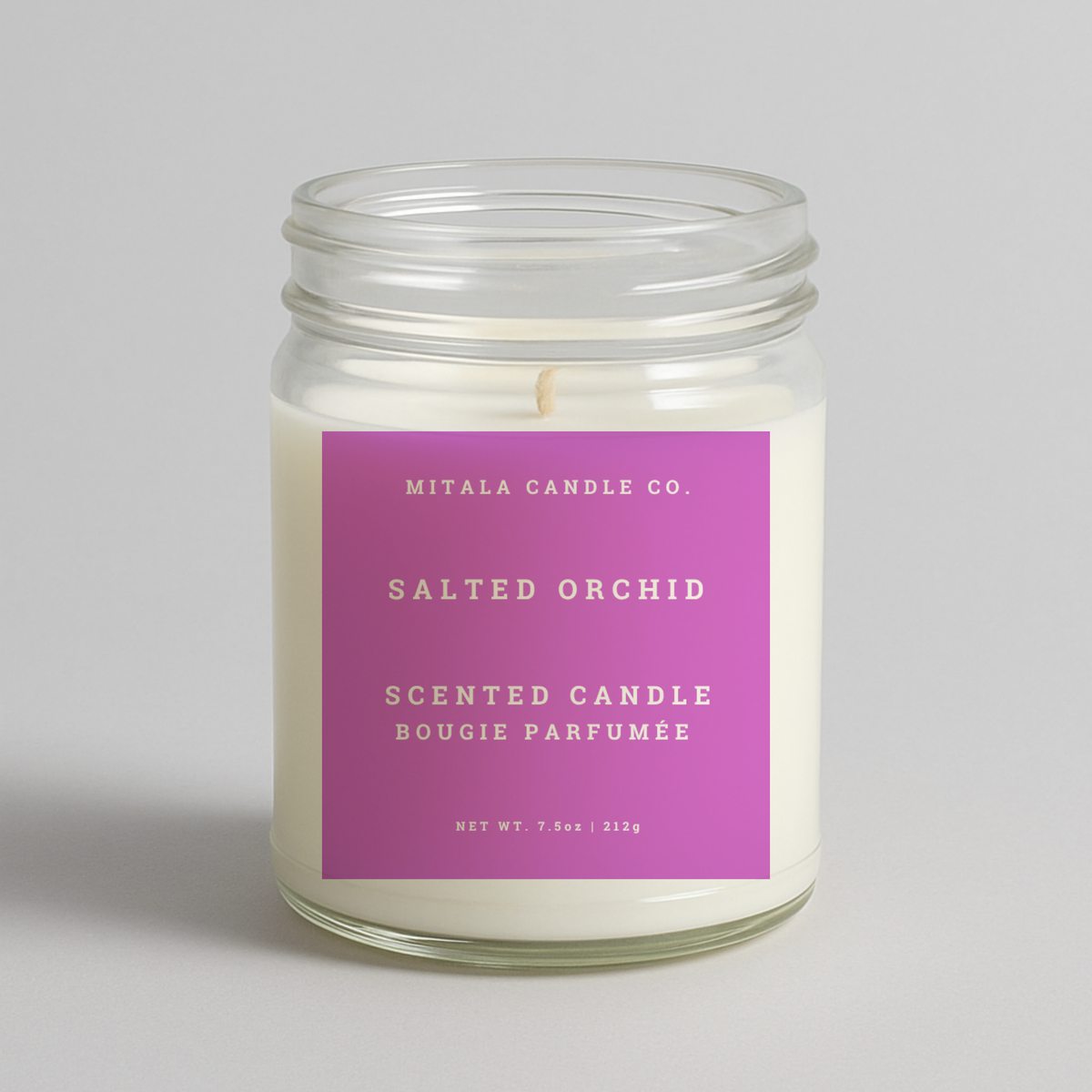 Mitala Candle Co. Salted Orchid scented candle with pink label, 7.5oz, on light gray background