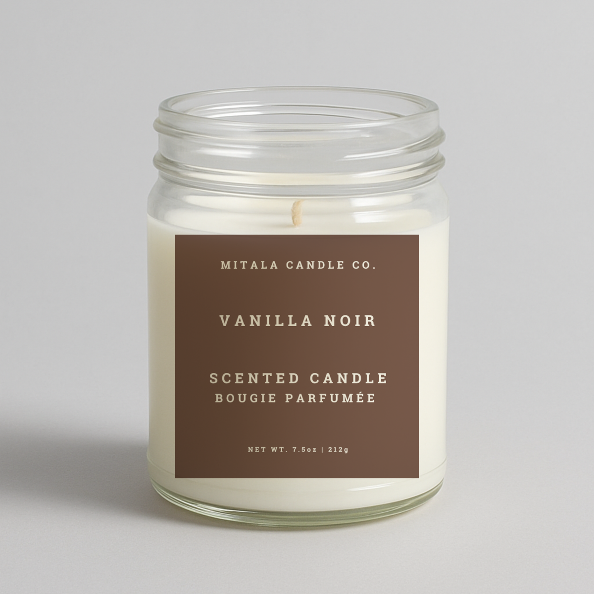 Mitala Candle Co. Vanilla Noir scented candle in glass jar with brown label, 7.5oz, on light gray background