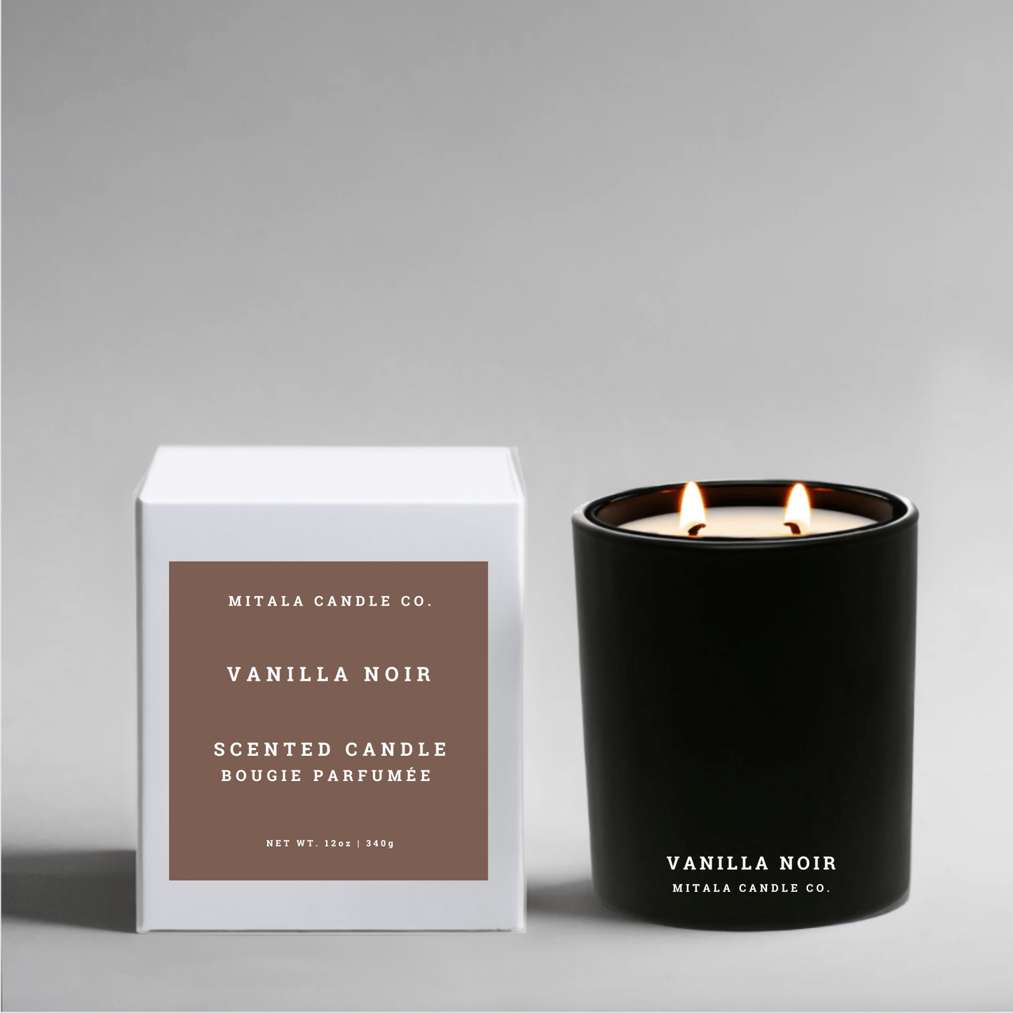 Vanilla Noir eco-luxury soy candle from Mitala Candle Co. with its white packaging on a gray background
