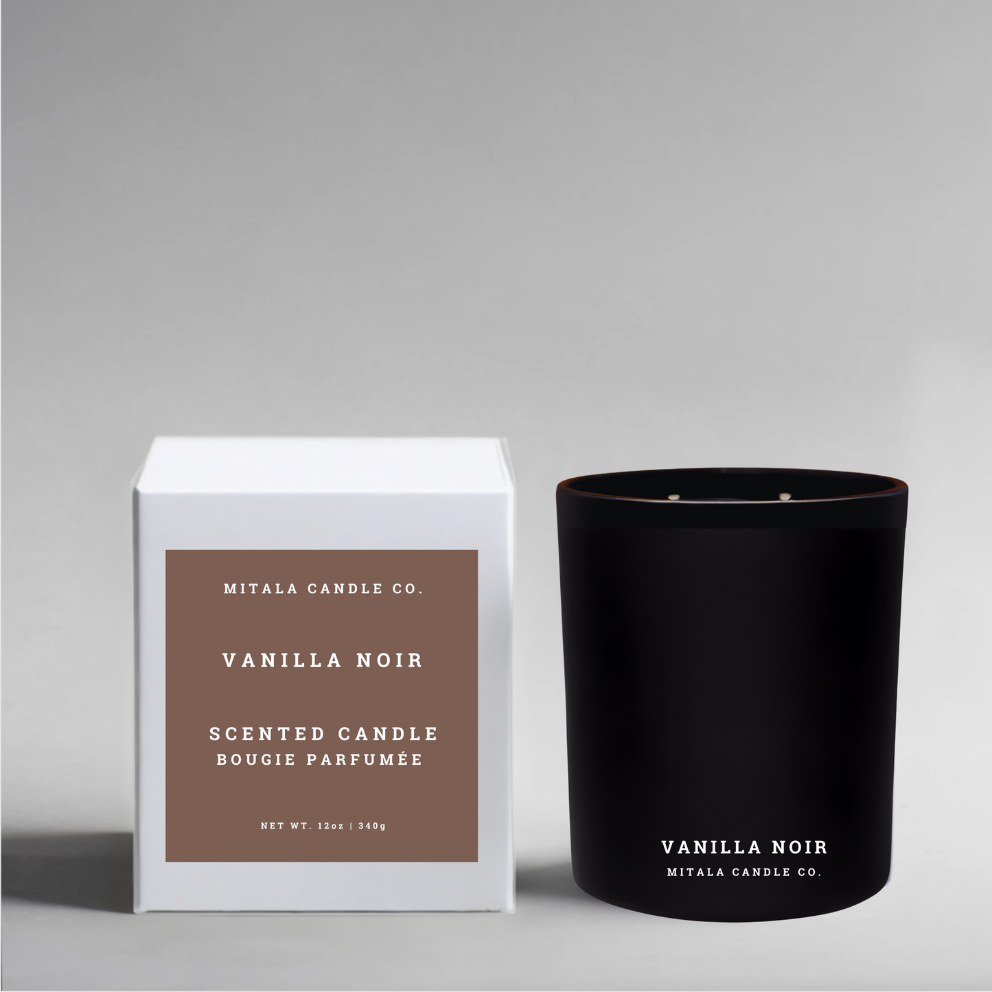 Vanilla Noir eco-luxury soy candle from Mitala Candle Co. with its white packaging on a gray background