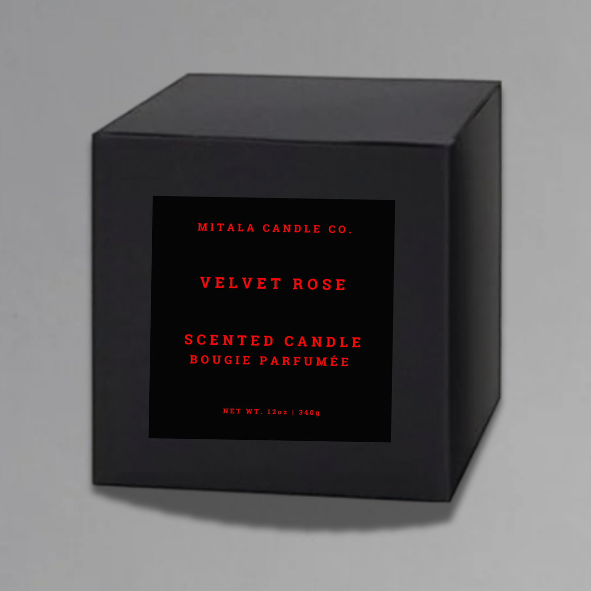 Luxury 12oz soy candle 'Velvet Rose' by Mitala Candle Co. next to white gift box on gray background
