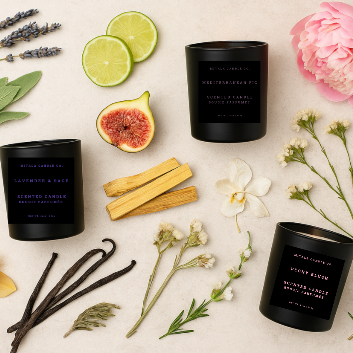 Three matte black scented candles from Mitali Candle Co. arranged in a styled flat lay with botanical and fruit props on a light beige background.