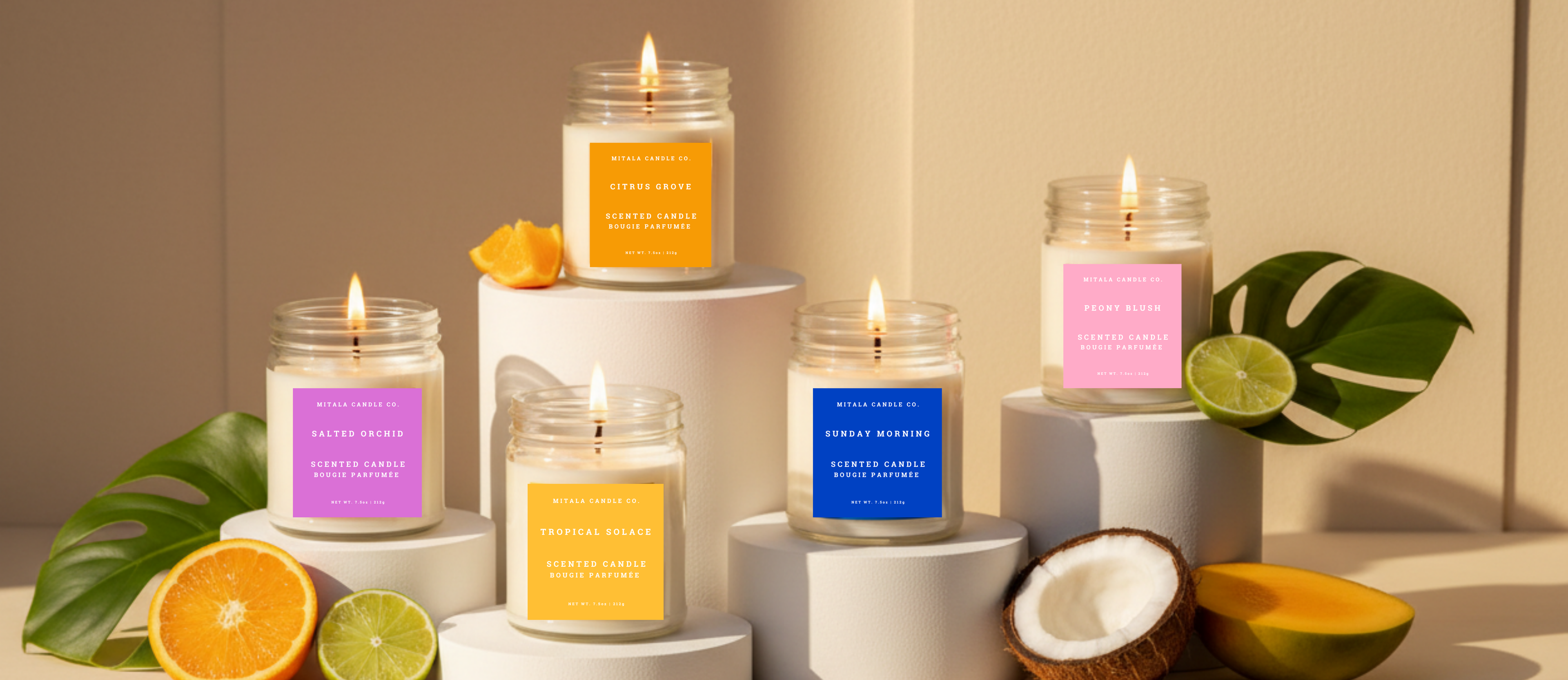 Five lit Mitala Candle Co. jar candles, Citrus Grove, Tropical Solace, Salted Orchid, Sunday Morning, and Peony Blush, styled in a summer lifestyle scene.