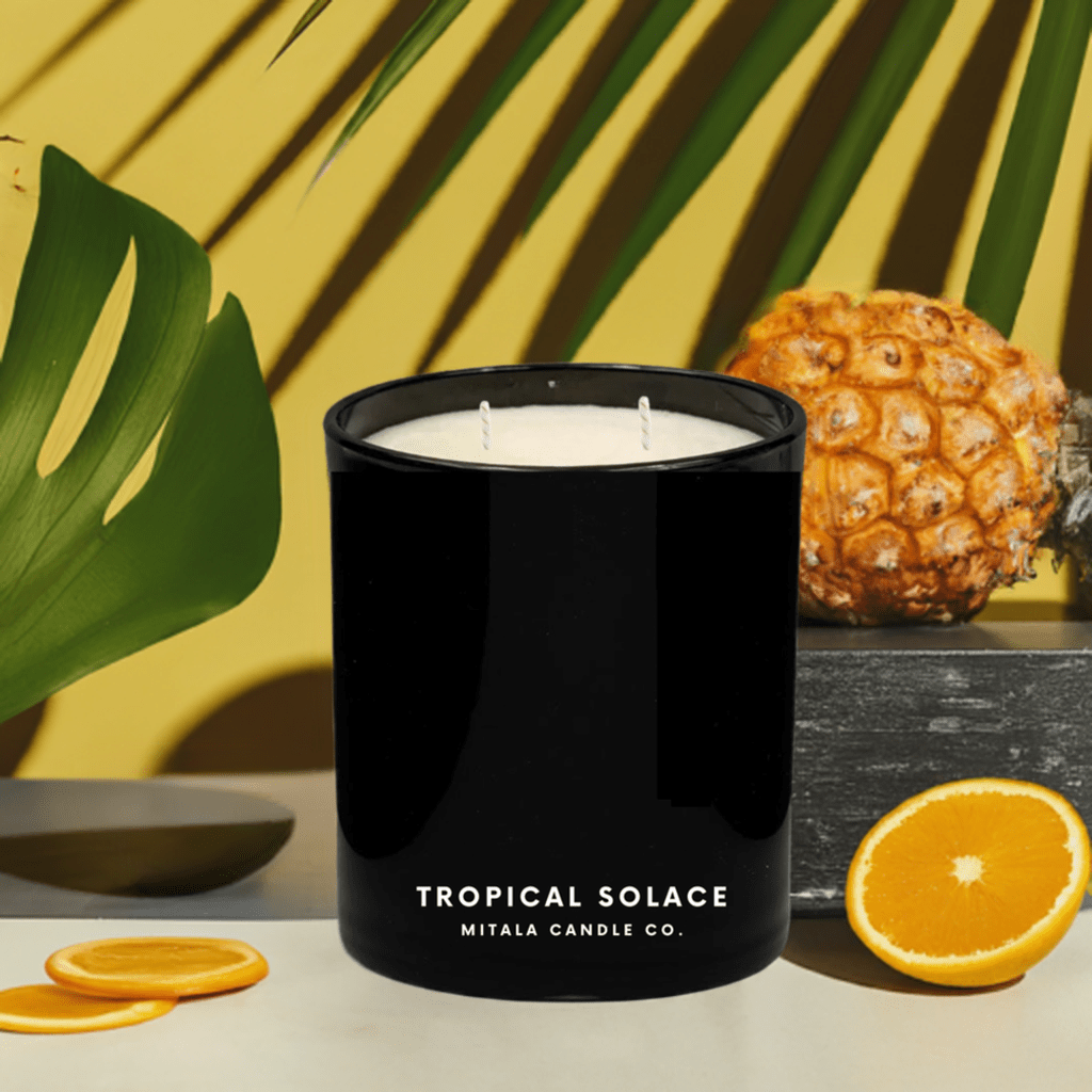 Mitala Candle Co. Tropical Solace hand-poured scented candle with tropical notes, in a black glass jar for a luxury home fragrance.