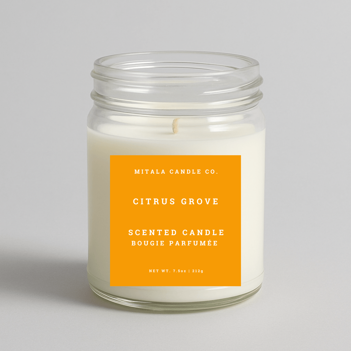 Mitala Candle Co. Citrus Grove scented candle with orange label, 7.5oz, on light gray background