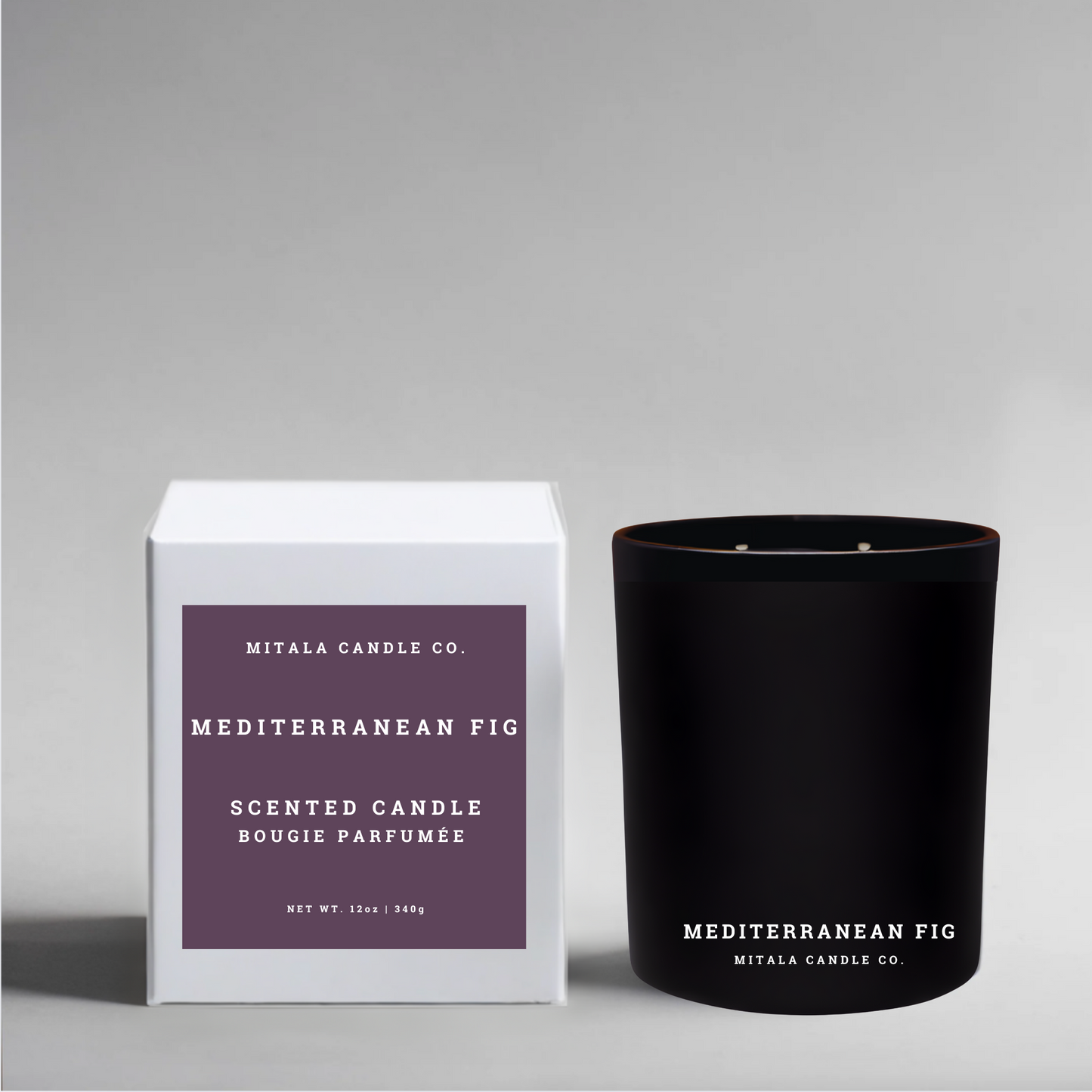 Luxury 12oz soy candle 'Mediterranean Fig' by Mitala Candle Co. next to white gift box on gray background