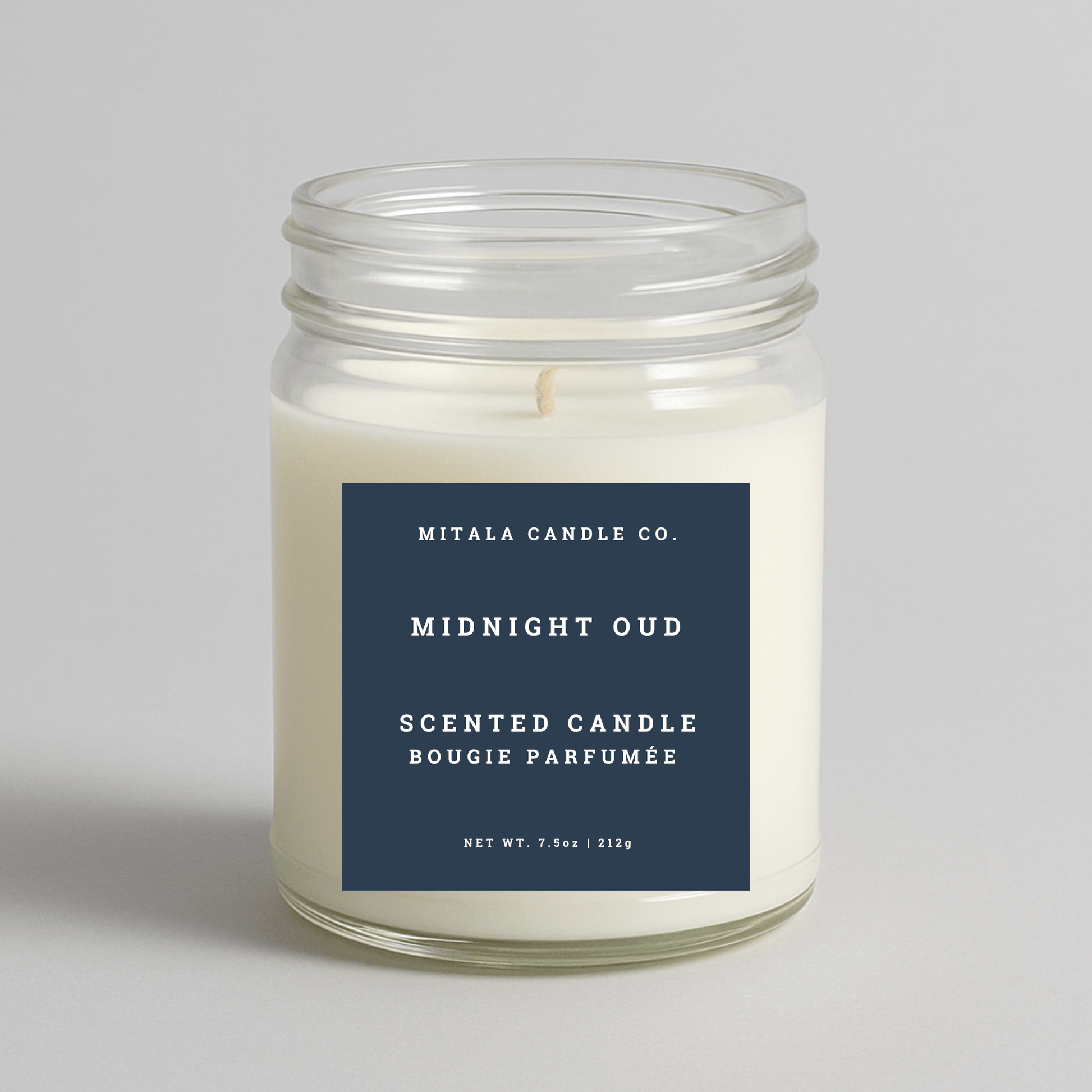 Mitala Candle Co. Midnight Oud scented candle with blue label, 7.5oz, on light gray background