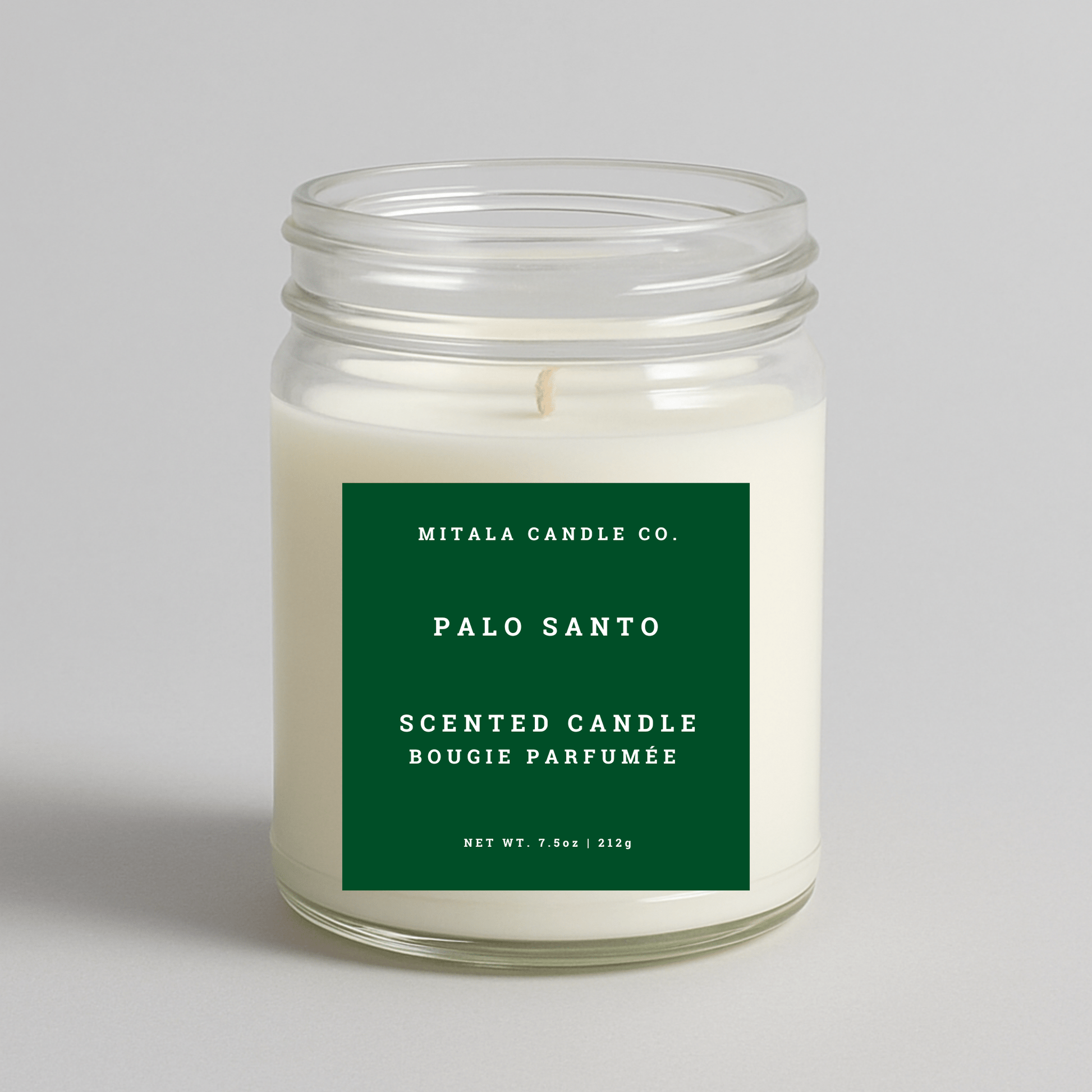 Mitala Candle Co. Palo Santo scented candle with green label, 7.5oz, on light gray background