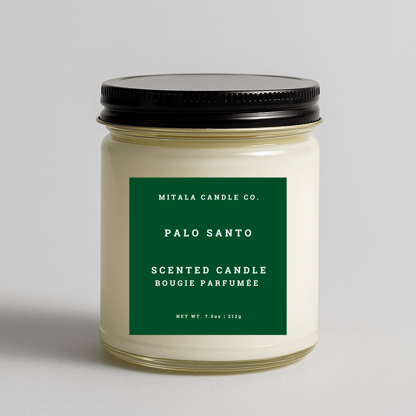 Mitala Candle Co. Palo Santo scented candle with green label and black lid, 7.5oz, on light gray background