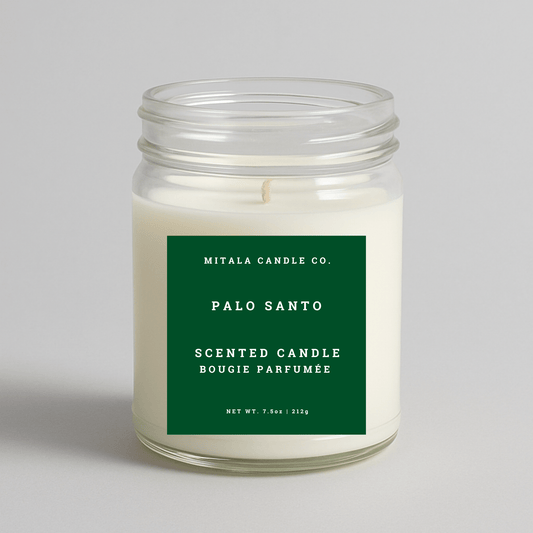 Mitala Candle Co. Palo Santo scented candle with a green label on a light gray background