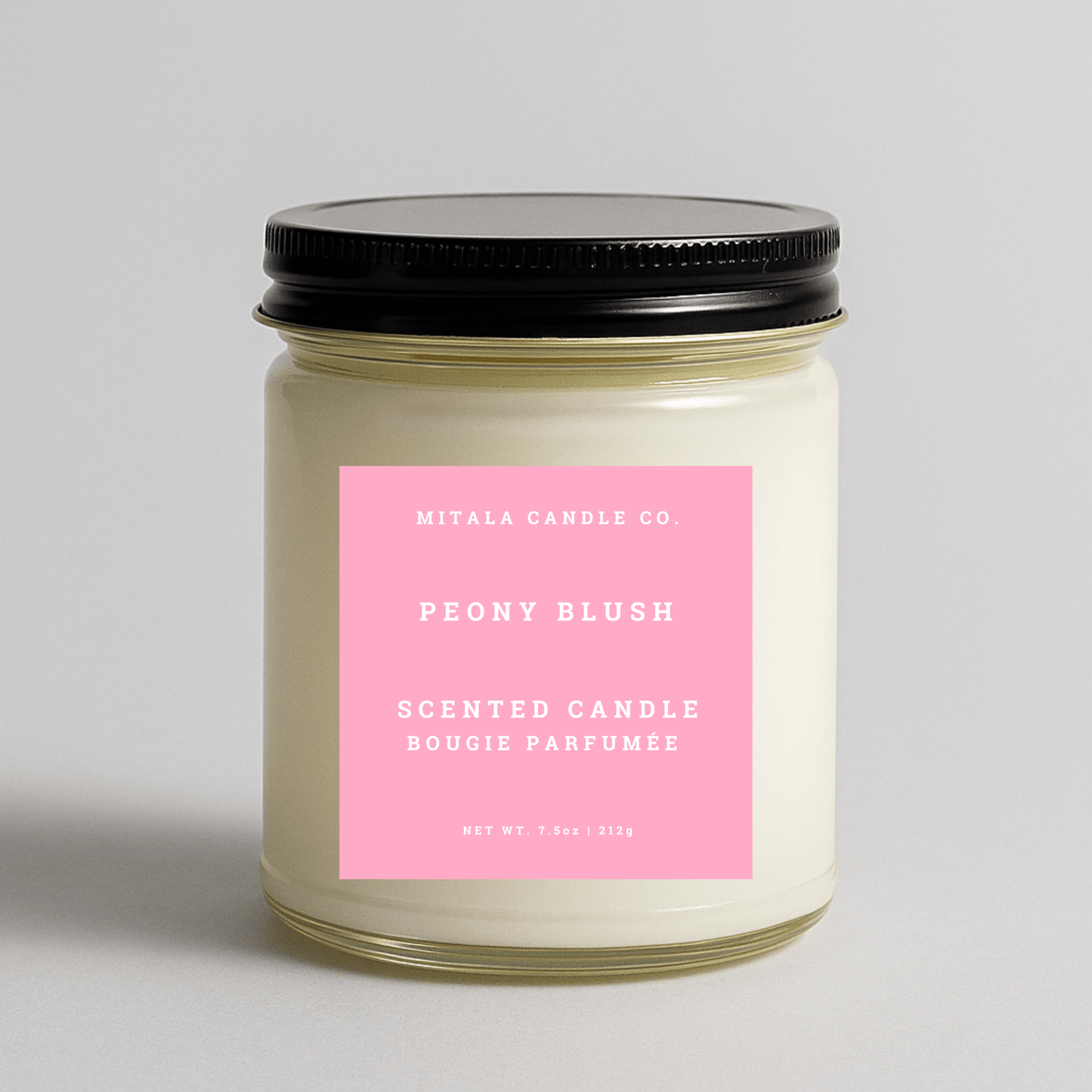 Mitala Candle Co. Peony Blush scented candle with pink label and black lid, 7.5oz, light gray background