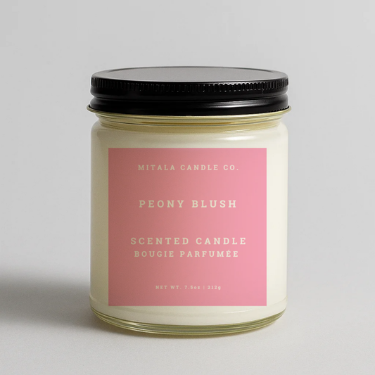 Mitala Candle Co. Peony Blush scented candle with pink label and black lid, 7.5oz, light gray background