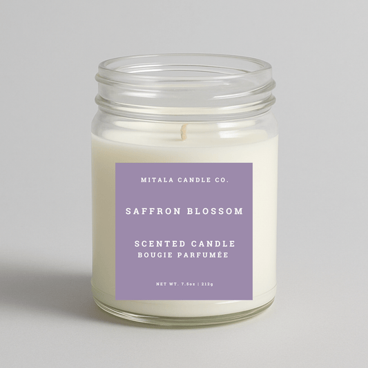 Mitala Candle Co. Saffron Blossom scented candle in glass jar with purple label, 7.5oz, on light gray background