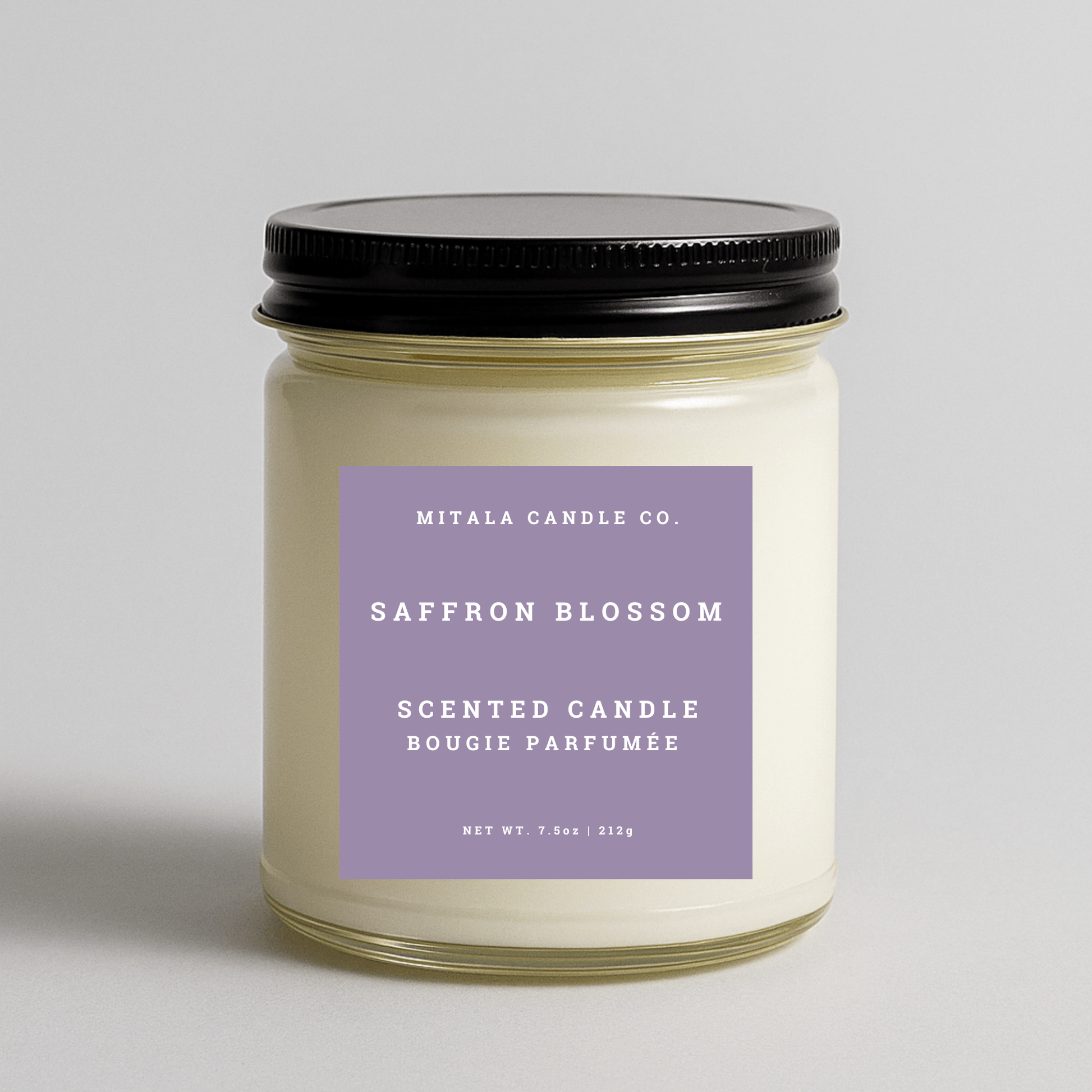 Mitala Candle Co. Saffron Blossom scented candle with purple label and black lid, 7.5oz, light gray background