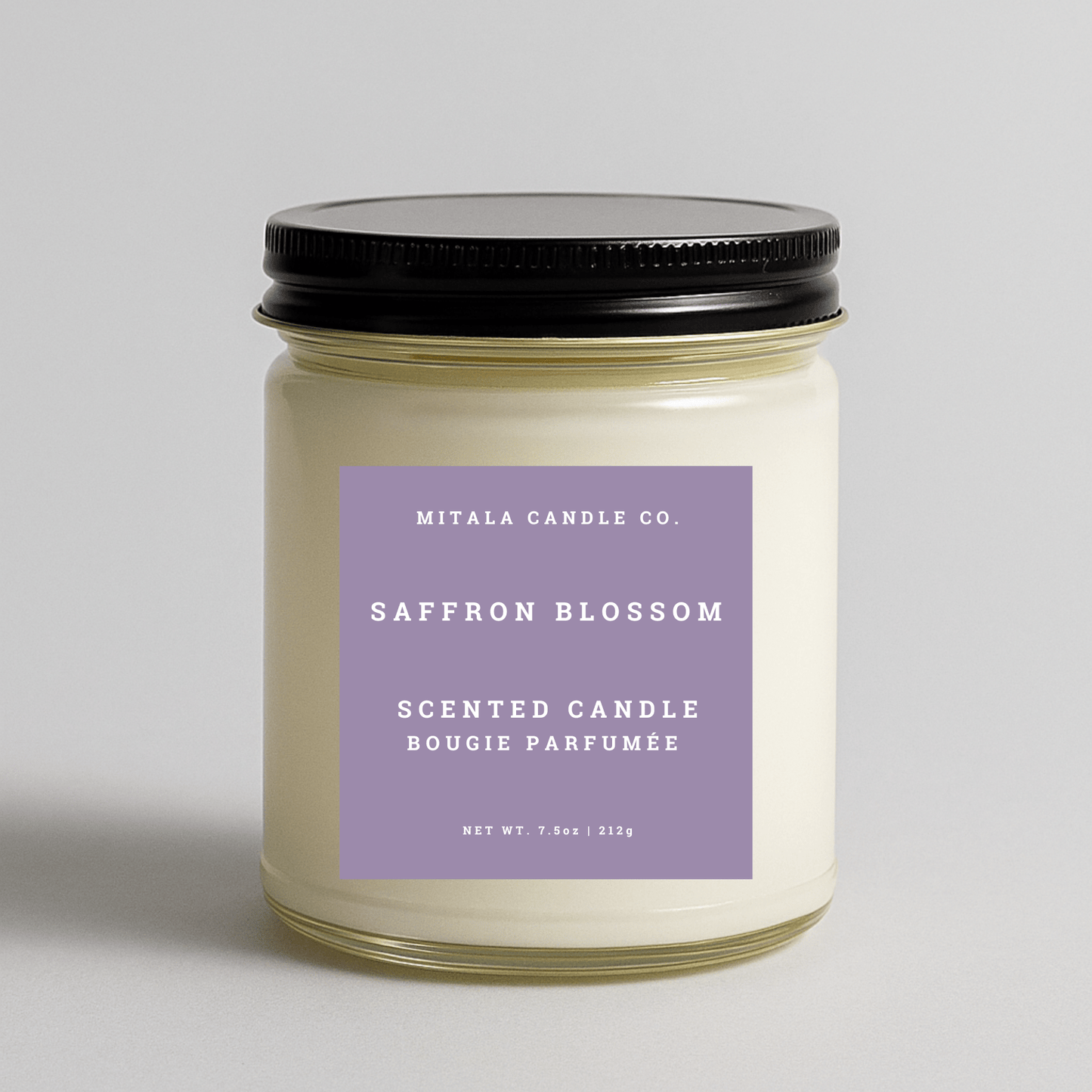 Mitala Candle Co. Saffron Blossom scented candle with a purple label on a light gray background