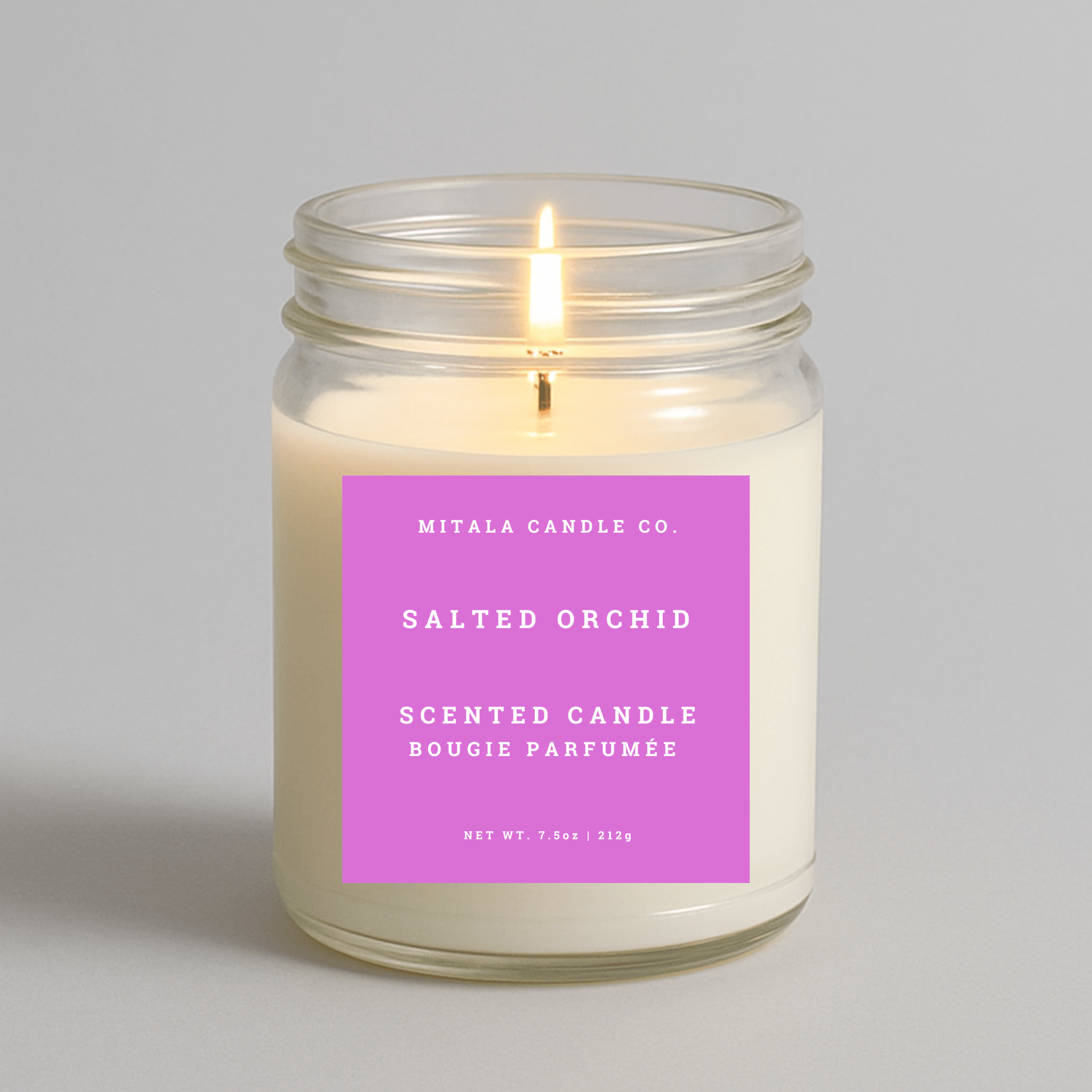 7.5oz Salted Orchid scented candle by Mitala Candle Co. with pink label, perfect for gifts or home decor