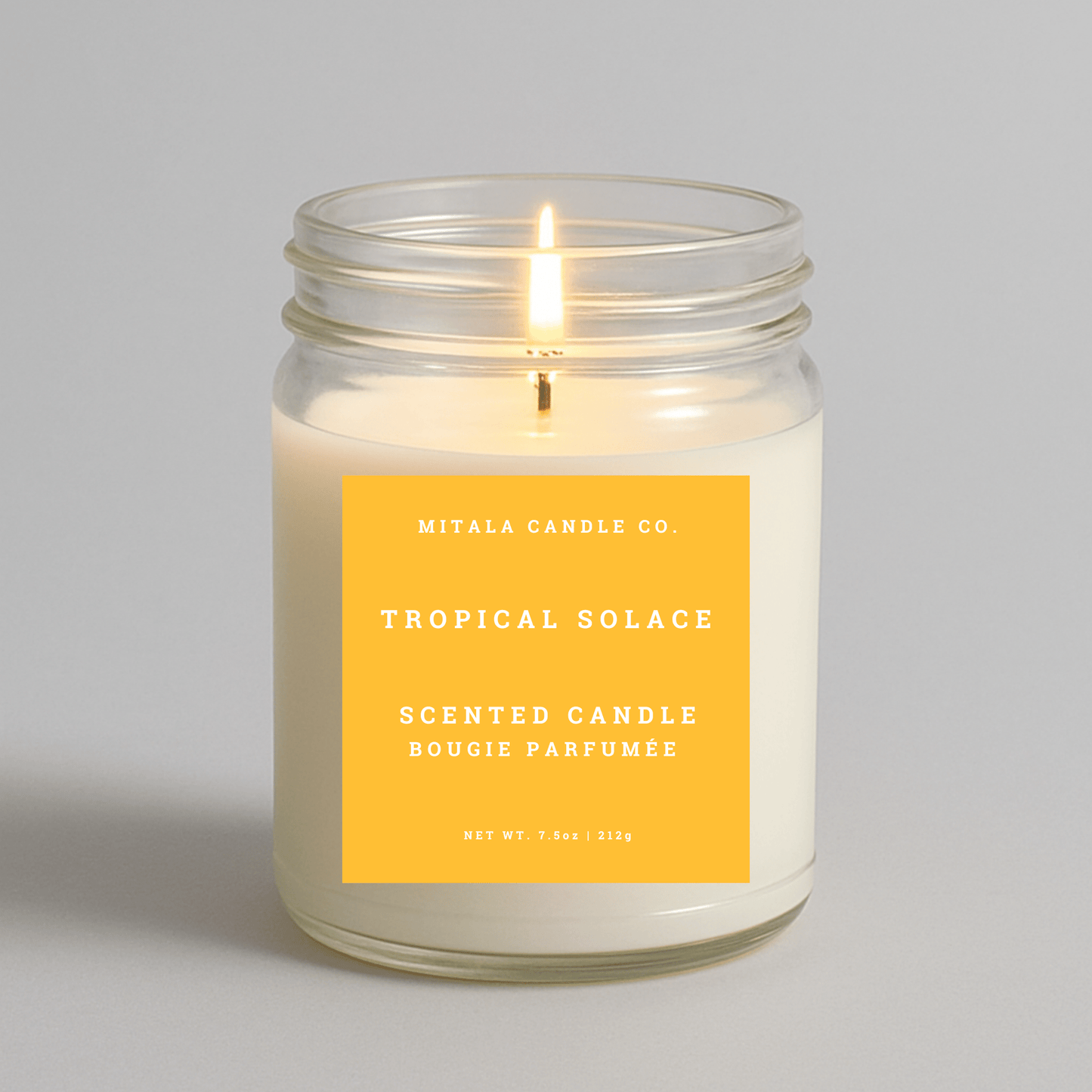 7.5oz Tropical Solace scented candle by Mitala Candle Co. with yellow label, perfect for gifts or home decor