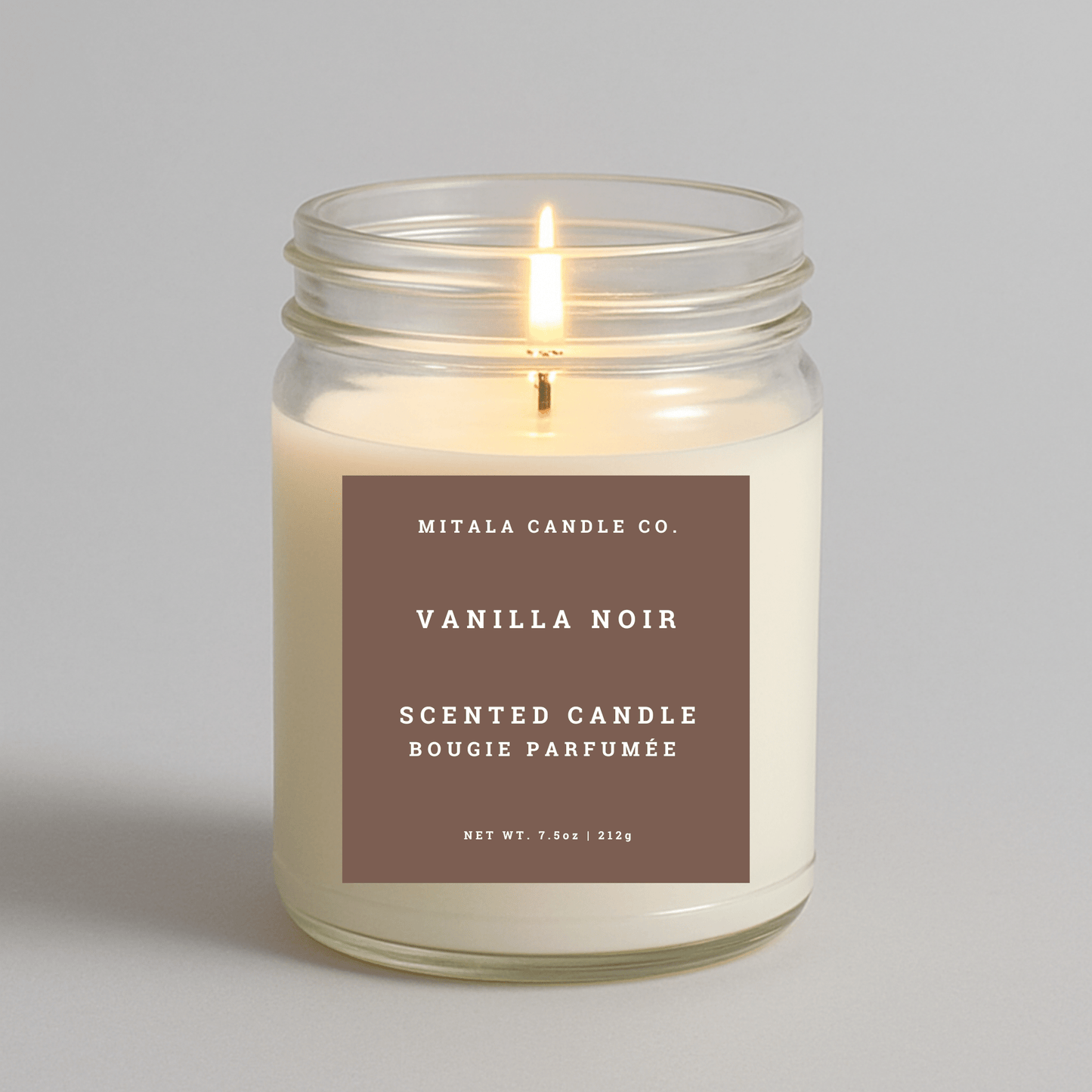 7.5oz Vanilla Noir scented candle by Mitala Candle Co. in glass jar with brown label, ideal for gifts or home decor