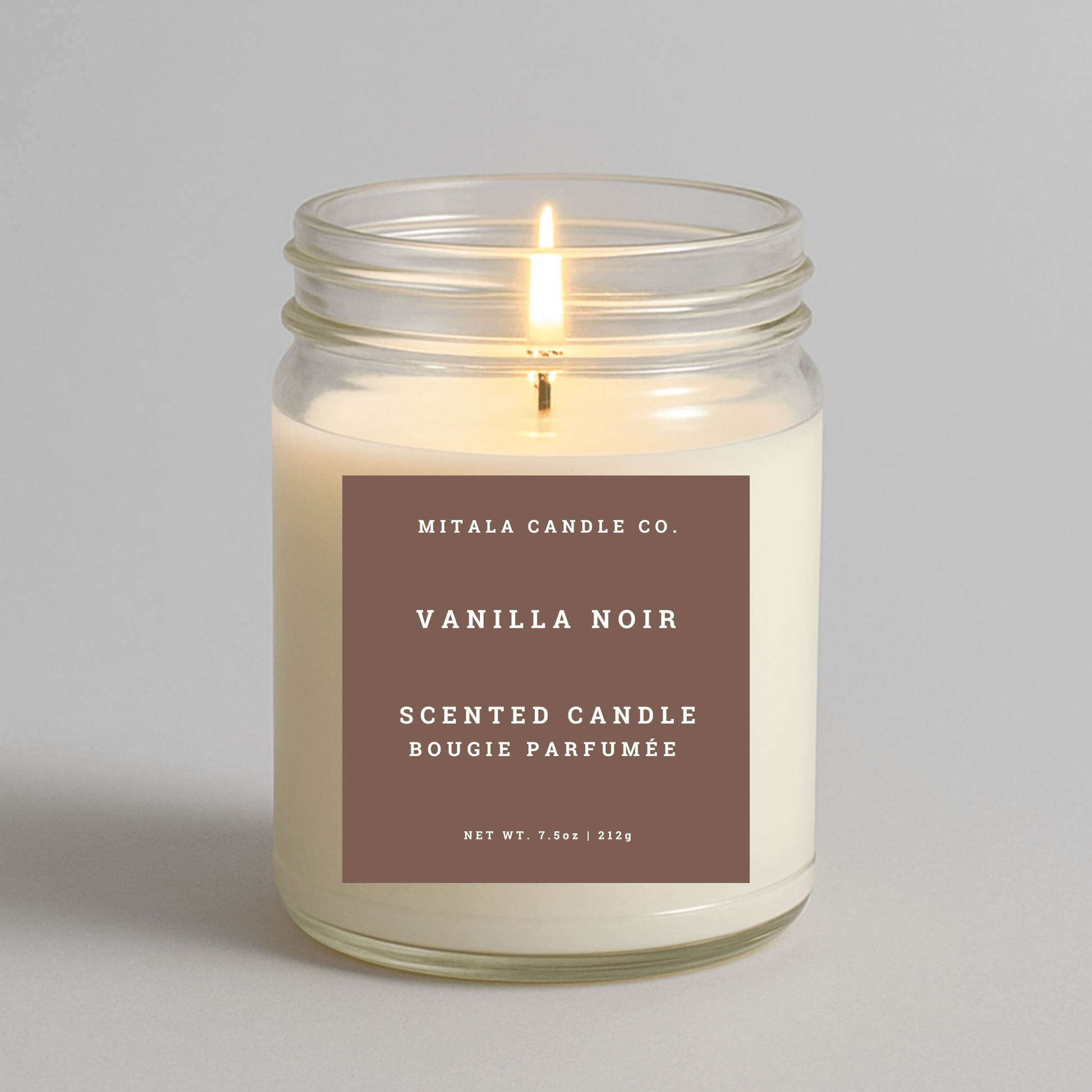 7.5oz Vanilla Noir scented candle by Mitala Candle Co. in glass jar with brown label, ideal for gifts or home decor