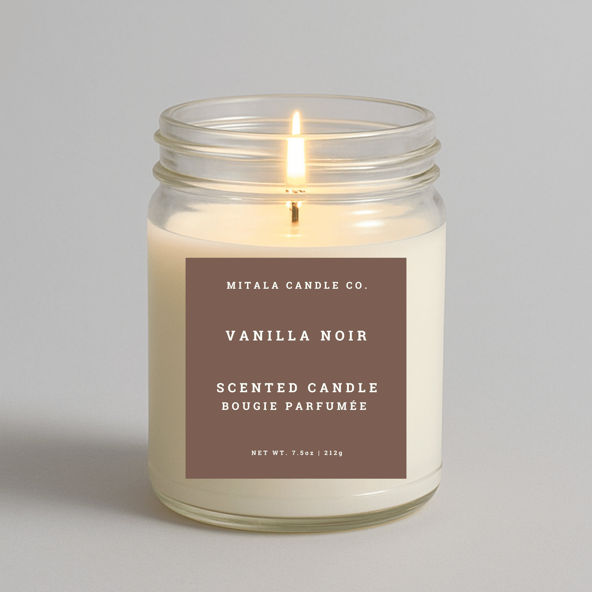 Mitala Candle Co. Vanilla Noir candle in a glass jar with a label on a gray background