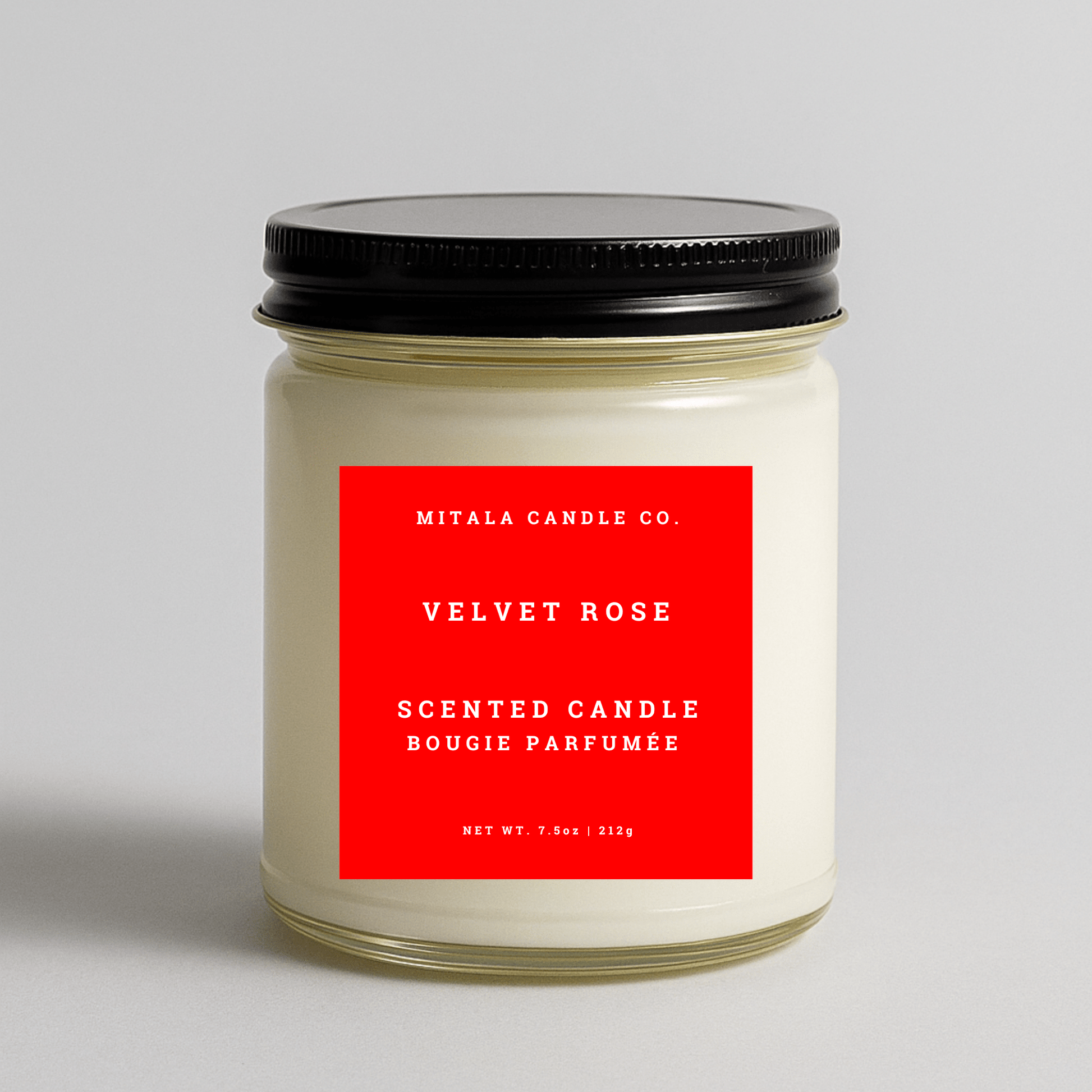 Mitala Candle Co. Velvet Rose scented candle with red label and black lid on gray background, 7.5oz