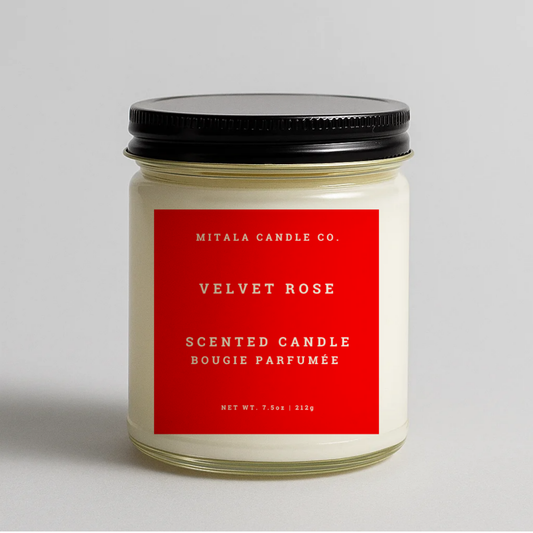 Mitala Candle Co. Velvet Rose scented candle with red label and black lid on gray background, 7.5oz