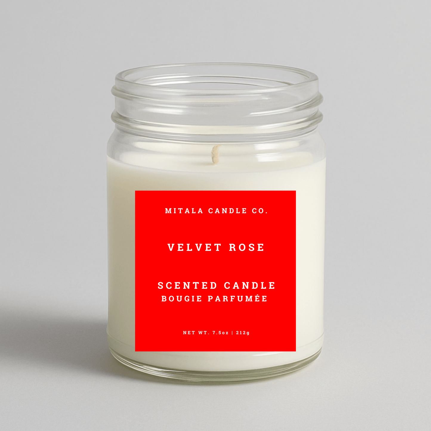 Mitala Candle Co. Velvet Rose scented candle with a red label on a light gray background